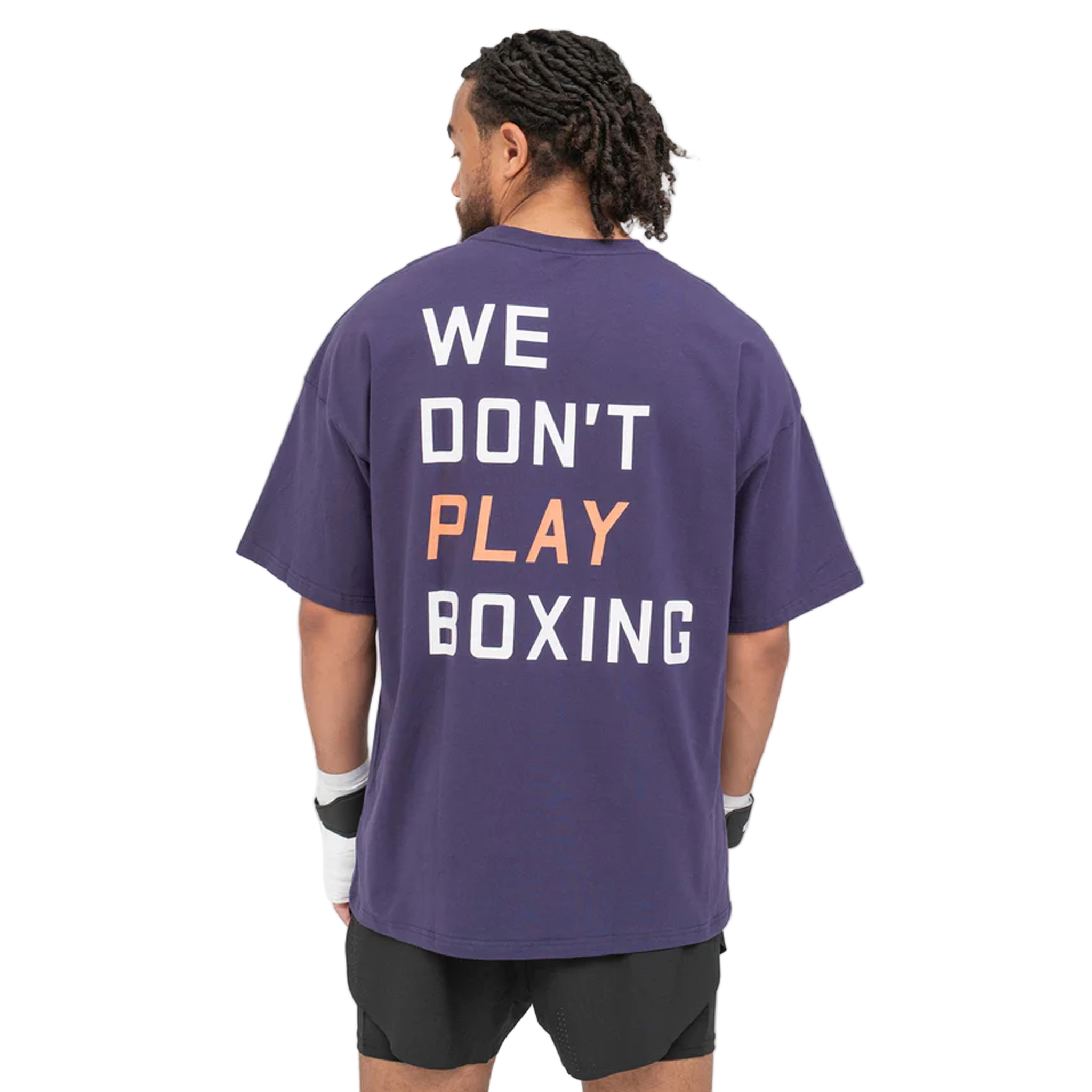 Man wearing a BOXRAW We dont play boxing oversised t shirt purple with 'WE DON'T PLAY BOXING' text on the back.