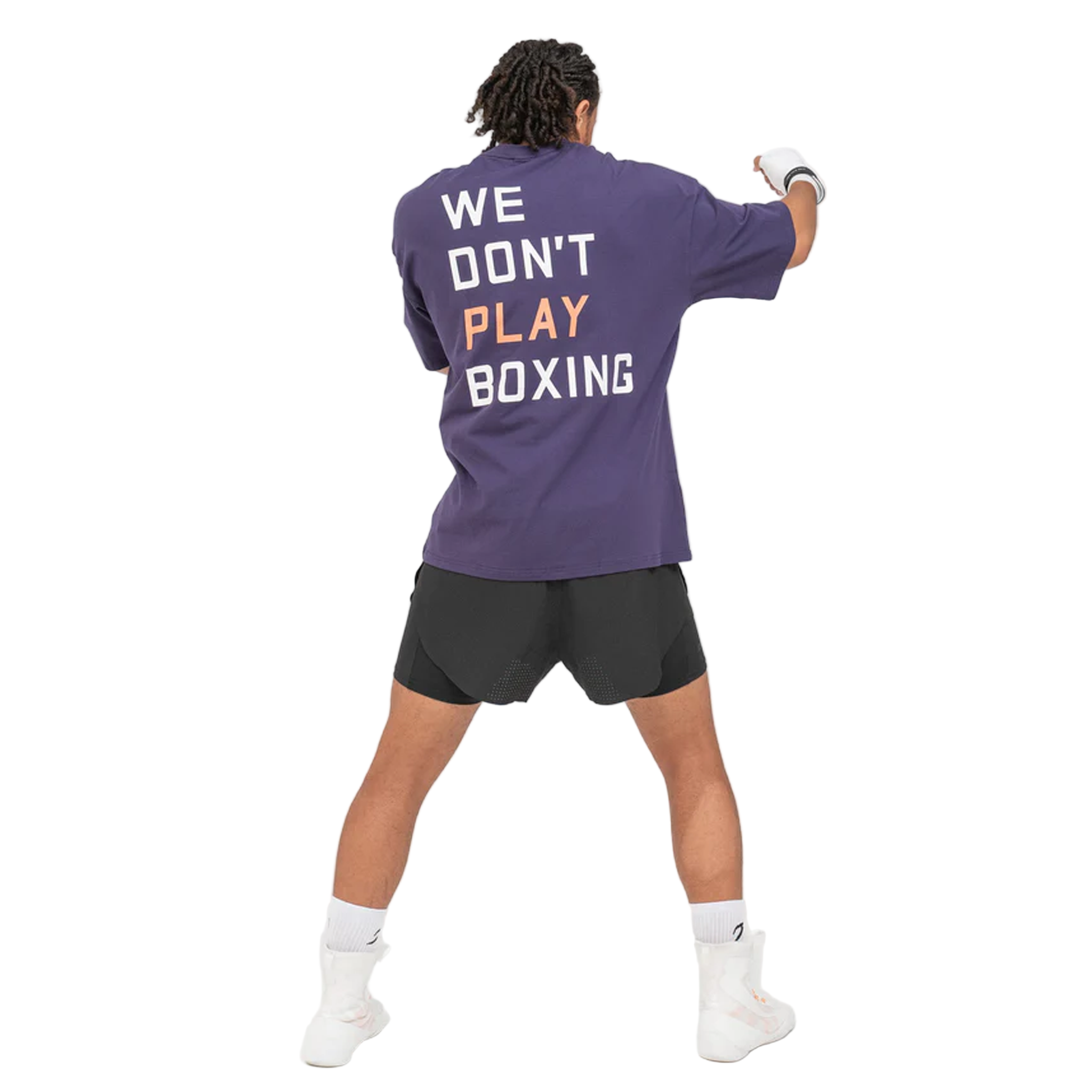 Man wearing a BOXRAW We dont play boxing oversised t shirt purple with 'WE DON'T PLAY BOXING' text on the back.