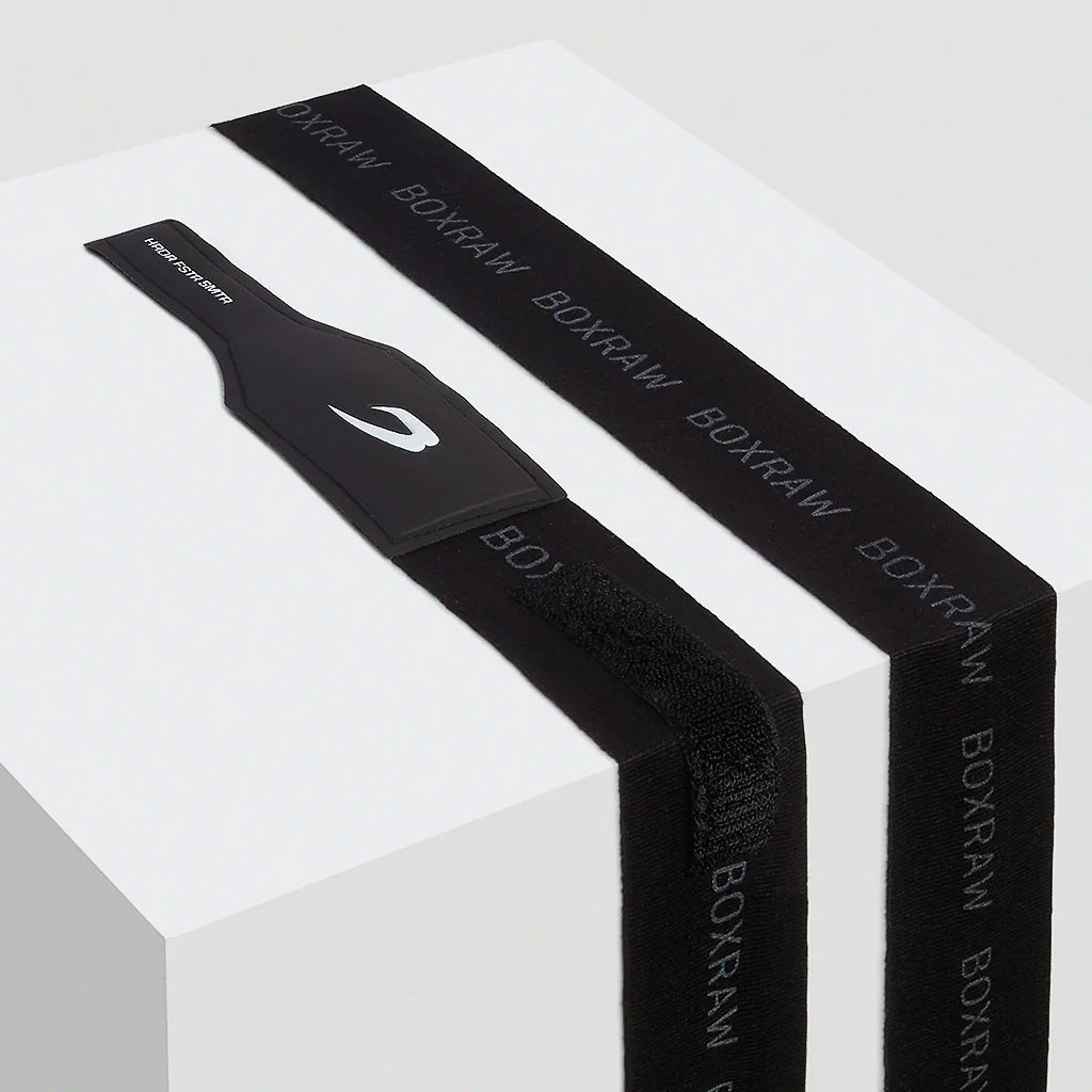 Black BOXRAW handwraps on a white box with a white background